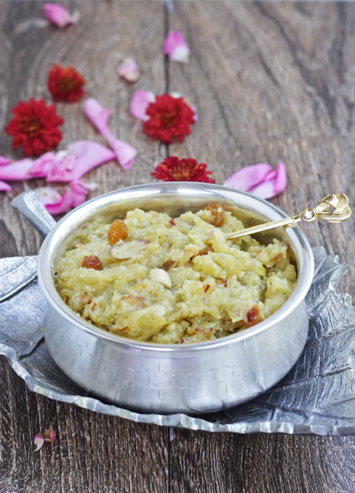 Bottle gourd halwa in silver bowl with a spoon 